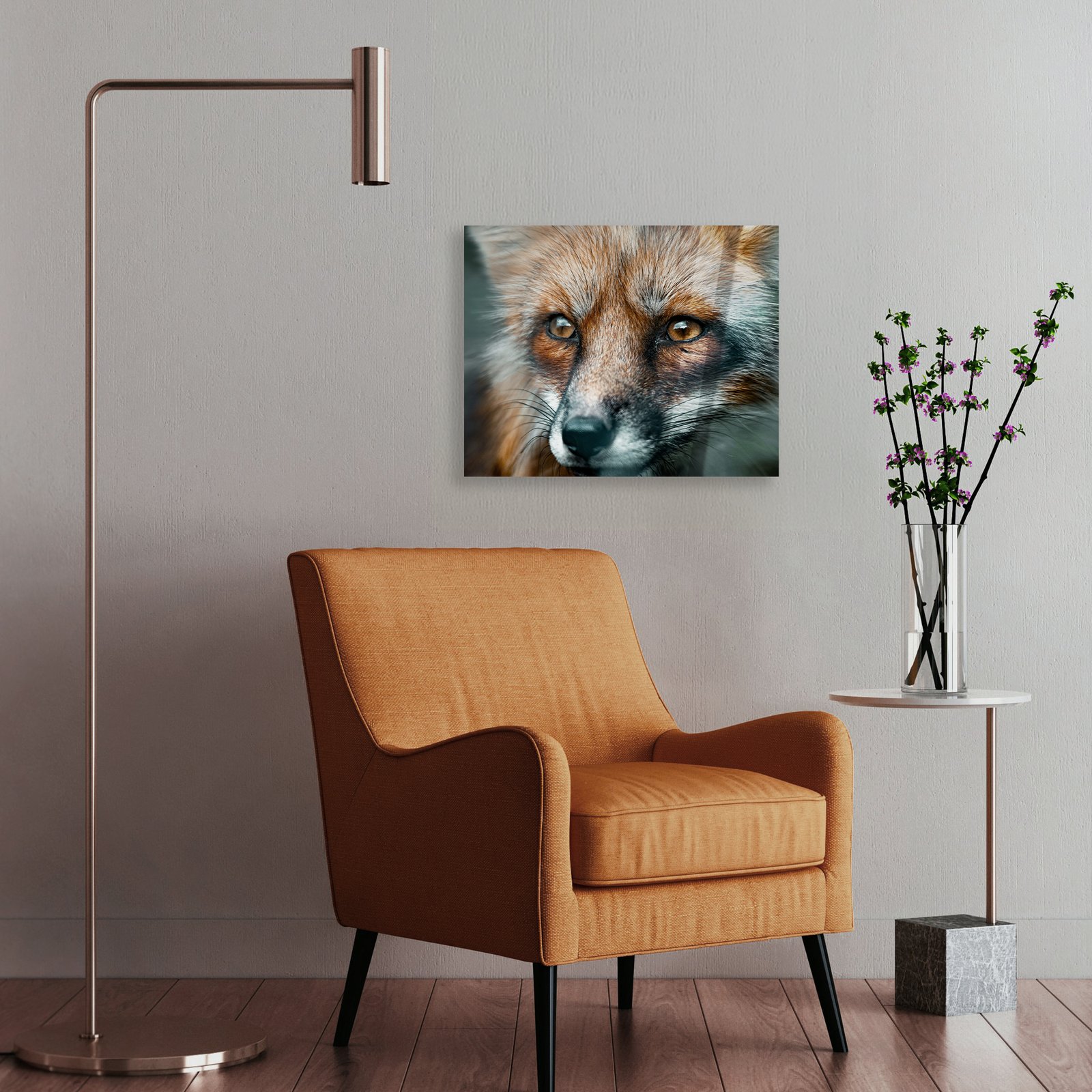 A horizontal 15x18.75 HD metal art print of a detailed red fox portrait mounted on a light gray wall in a modern living room setting, positioned above a mid-century orange accent chair next to a sleek floor lamp.