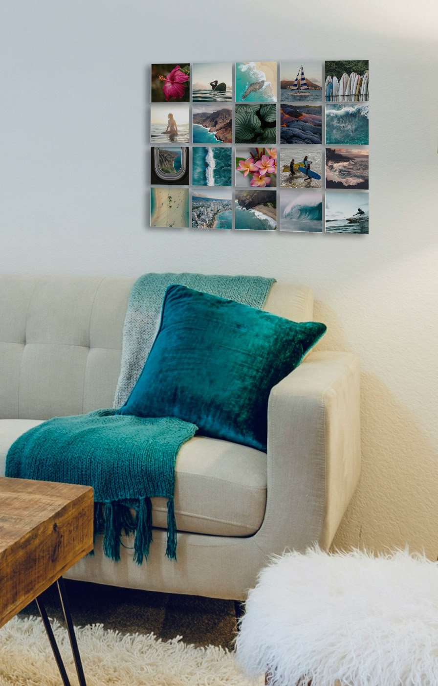 A modern living room couch mockup featuring a large 20-panel wall gallery grid made of 5x5 square custom surf and ocean photo metal prints arranged 4 high and 5 across.