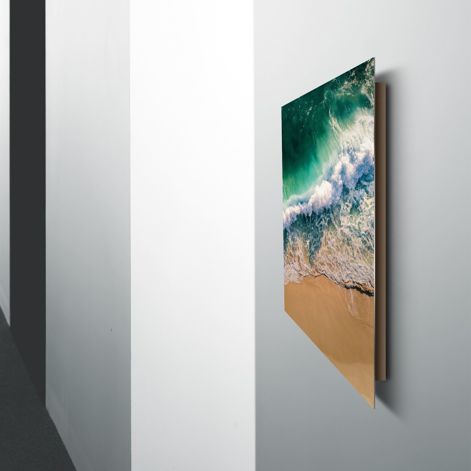 A modern home office desk setup with an iMac, featuring a vibrant mountain landscape metal print hanging on the wall.